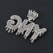 Load image into Gallery viewer, Silver dripping letters pendant with crown lying on dark fabric, side view