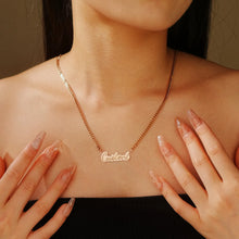 Load image into Gallery viewer, Woman in a black top wearing a dainty double plated cursive name necklace