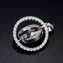 Load image into Gallery viewer, Silver spinning photo pendant turned sideways to show the round photo spinning inside the CZ halo