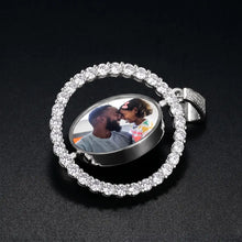 Load image into Gallery viewer, Silver rotating pendant turned sideways to show the round photo rotating inside the CZ halo