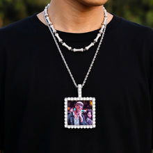 Load image into Gallery viewer, Man wearing a silver square photo necklace with a family picture inside, showing its real size on the chest