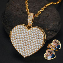 Load image into Gallery viewer, Yellow gold personalized photo heart locket necklace resting on a stone, featuring a custom picture of a couple inside.