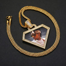 Load image into Gallery viewer, 14k yellow gold triangle photo pendant necklace attached to a matching cuban link chain against a dark background.