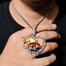 Load image into Gallery viewer, A person holding the GetEngravings white gold custom iced out heart necklace, showing its premium size and intricate stone detailing.