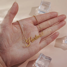 Load image into Gallery viewer, Script name necklace held in a hand to show its real size