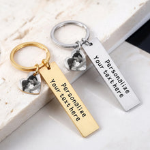 Load image into Gallery viewer, Gold and silver heart picture keychains with black and white photos and engraved bars on marble