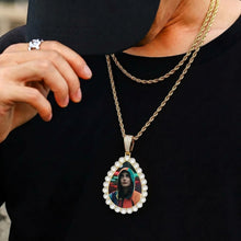 Load image into Gallery viewer, Model wearing an iced out teardrop photo pendant on a chain, showing its real size