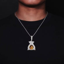 Load image into Gallery viewer, A model wearing the white gold plated iced-out money bag custom picture pendant on a silver rope chain.