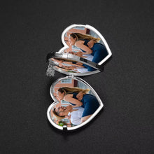 Load image into Gallery viewer, Opened silver photo heart locket resting on a black surface, revealing a custom personalized picture of a couple inside.