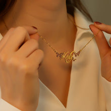 Load image into Gallery viewer, Woman holding her gold butterfly name necklace to show the script name pendant up close