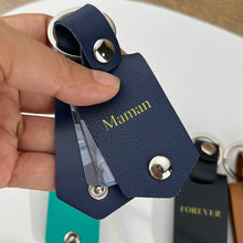 Load image into Gallery viewer, Personalized navy leather photo keychain with a gold name, opened to show the photo cards inside