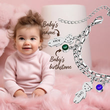 Load image into Gallery viewer, Baby next to a personalized mom bracelet showing the baby's name charm and birthstone