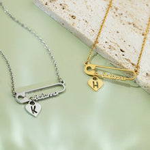 Load image into Gallery viewer, Two personalized safety pin necklaces in gold and silver with initial hearts