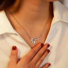 Load image into Gallery viewer, Woman wearing a silver safety pin name necklace with a heart initial charm
