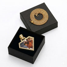 Load image into Gallery viewer, GetEngravings yellow gold triangle photo memory pendant elegantly displayed inside a black gift box with a chain.