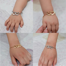 Load image into Gallery viewer, Close-up of engraved name heart charms on a gold bangle bracelet for mom