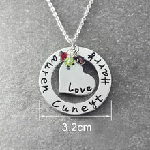 Load image into Gallery viewer, Close-up of engraved open-circle necklace showing laser-engraved lettering and inner heart charm