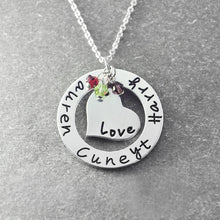 Load image into Gallery viewer, Custom name circle necklace with heart pendant on a silver chain, shown from an angle