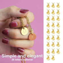 Load image into Gallery viewer, Gold-plated initial disc charms held in hand, showing engraved letters