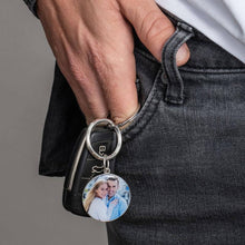 Load image into Gallery viewer, Hand holding a full color round photo keychain to show its real size
