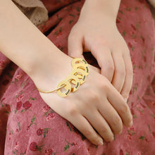 Load image into Gallery viewer, Personalized gold bracelet with children's names worn on a woman's wrist