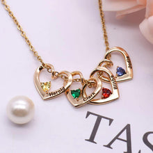 Load image into Gallery viewer, Rose gold heart pendant necklace with birthstones displayed on a surface