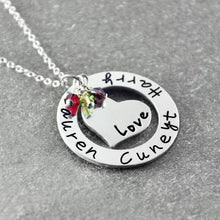 Load image into Gallery viewer, Silver-color circle pendant necklace engraved with the names Lauren, Harry and Cuneyt around a heart charm