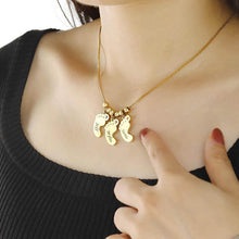 Load image into Gallery viewer, Woman wearing personalized baby feet birthstone necklace, close-up on neckline
